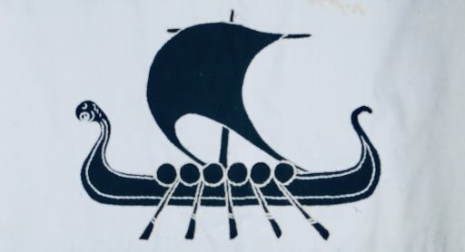 Heraldic blazon: Per fess azure and sable, on a fess argent, a Viking longship sable